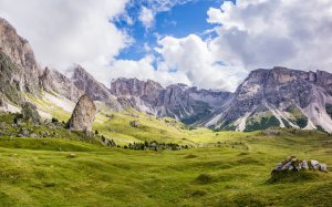 Зеленые холмы у подножия гор - скачать обои на рабочий стол